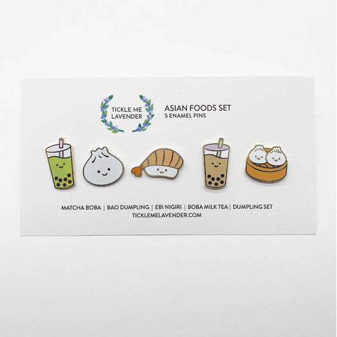 Set of five enamel pins featuring Asian foods on a branded card.