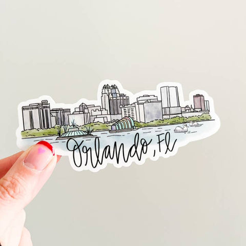 Sticker of Orlando, FL skyline held by a hand on a light gray background