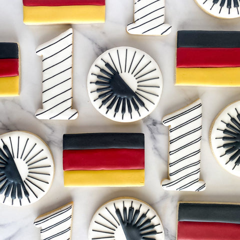 Decorative cookies with German flag design on a marble surface