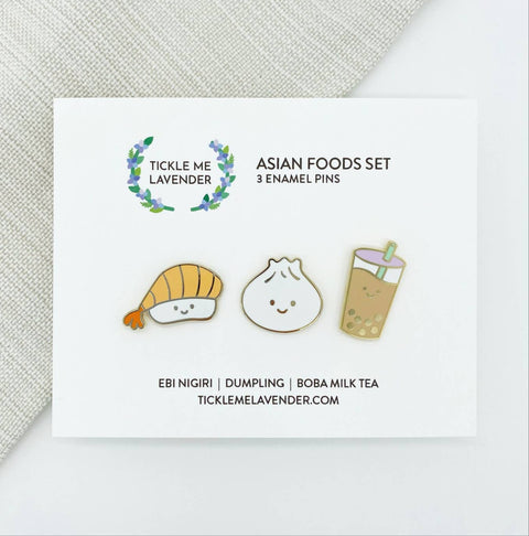 Three enamel pins of Ebi Nigiri, Dumpling, and Boba Milk Tea on a card with 'Tickle Me Lavender' branding.