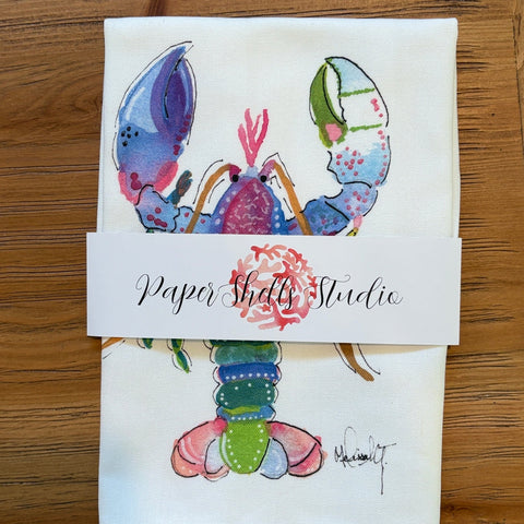 Colorful lobster illustration on a folded piece of paper with 'Paper Shelly Studio' label.
