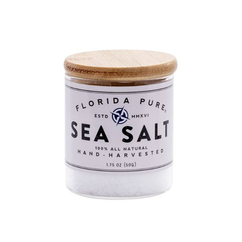 Jar of Florida Pure Sea Salt with wooden lid on a white background