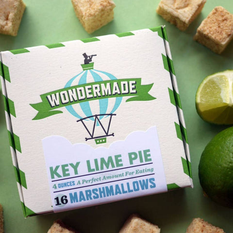 Box of Wondermade Key Lime Pie marshmallows with marshmallows and a lime on a green background