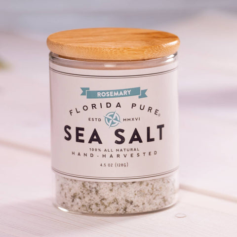 Jar of Florida Pure Sea Salt with a wooden lid on a light background