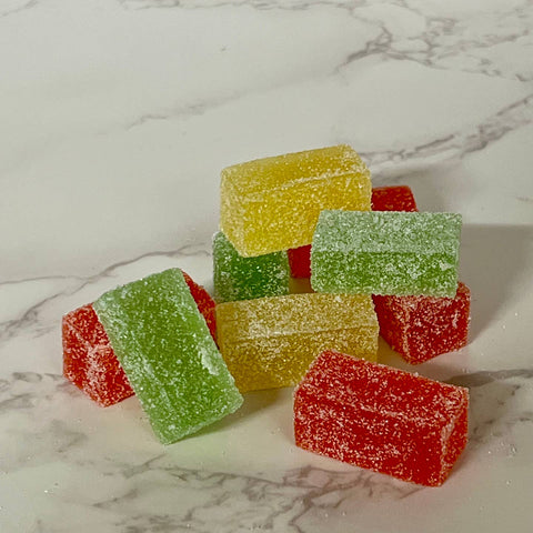 Colorful gummy cubes on a marble surface