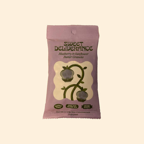 Sweet Deliverance blueberry and sunflower butter granola package on a beige background