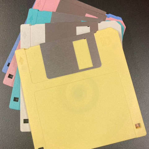 Stack of colorful floppy disks on a dark surface