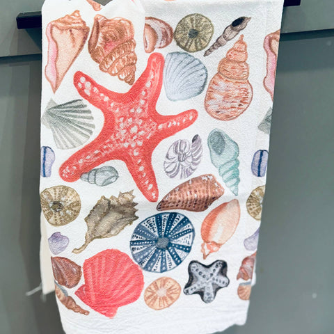 Towel with colorful shell and starfish pattern on a white background