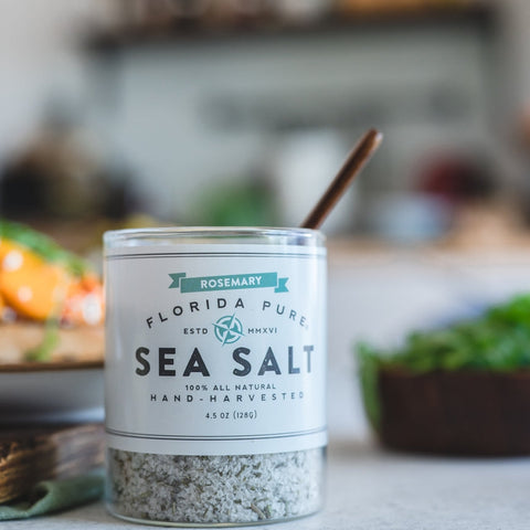 Container of Florida Pure Sea Salt on a kitchen counter with blurred background