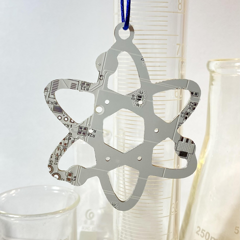 Star-shaped metallic object with intricate patterns on a white background