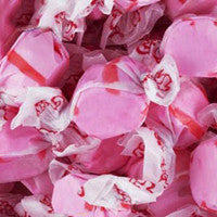 Pink taffy candy with white drizzle on a pink background
