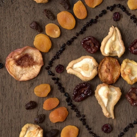 Assorted dried fruits on a wooden surface