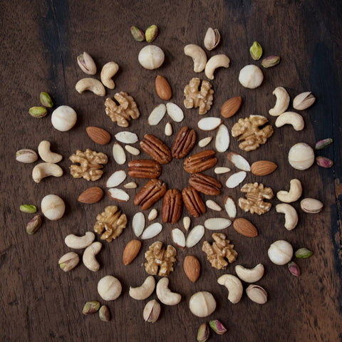 Decorative arrangement of nuts on a wooden surface