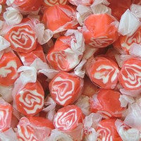 Assorted hard candies with red and white swirl patterns.