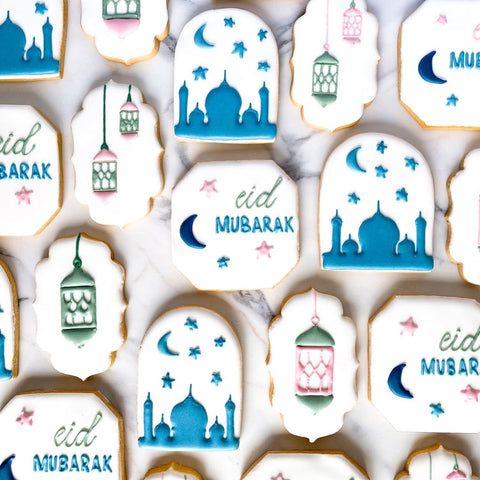 Decorative cookies with 'eid Mubarak' text and Islamic patterns on a white background