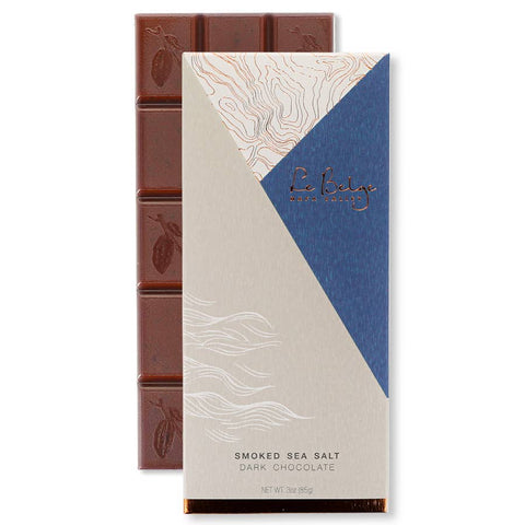 Dark chocolate bar with packaging featuring a blue and beige design.