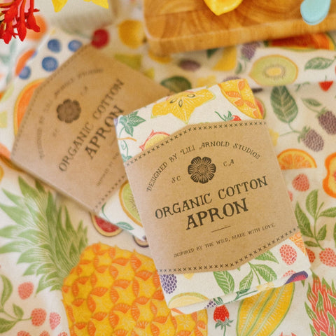 Organic cotton apron with fruit pattern on a colorful background