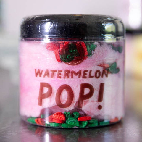 Jar of 'Watermelon Pop!' candy with pink candy balls and black lid.