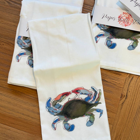 Napkins with blue crab design on a wooden surface