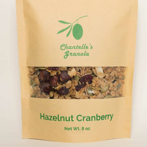 Kraft paper packaging of Chantelle's Granola Hazelnut Cranberry flavor on a light beige background