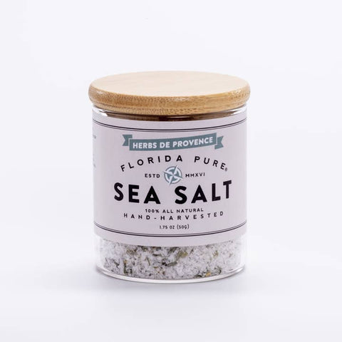 Jar of Florida Pure Sea Salt with a wooden lid on a white background