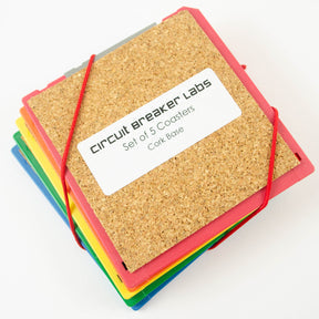 Set of five cork boards with colorful borders and a label on a white background