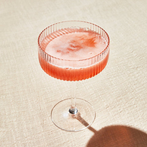 Cocktail in a textured glass on a light surface