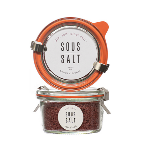 Jar of sous salt with orange lid on a white background