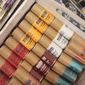 Assorted paint tubes in a drawer with visible brand labels.