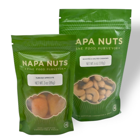 Two green packages of Napa Nuts on a white background