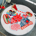 Round white coaster with colorful 'Chicago' themed stickers on a gray surface.