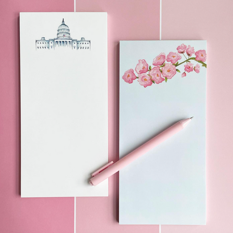Two stationery items with designs on a pink tiled background