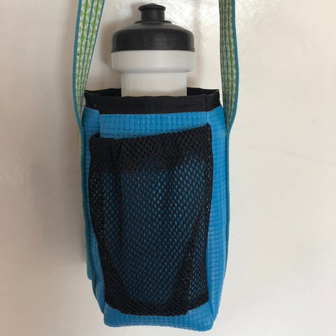 Blue water bottle holder with a white water bottle on a light gray background