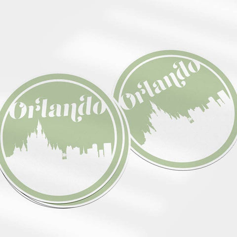 Two round stickers with 'Orlando' text and city silhouette on a white background