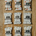 Multiple packages of 'patter bar' on a wooden surface