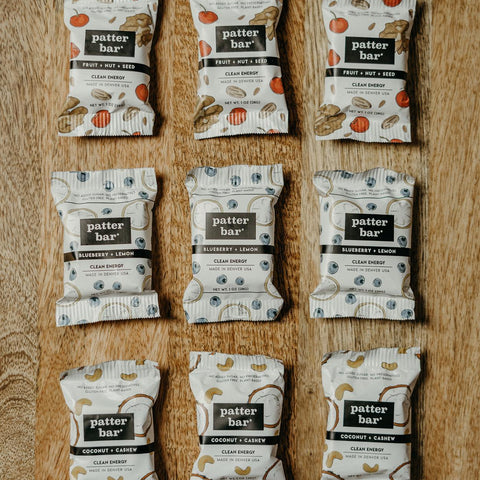 Multiple packages of 'patter bar' on a wooden surface