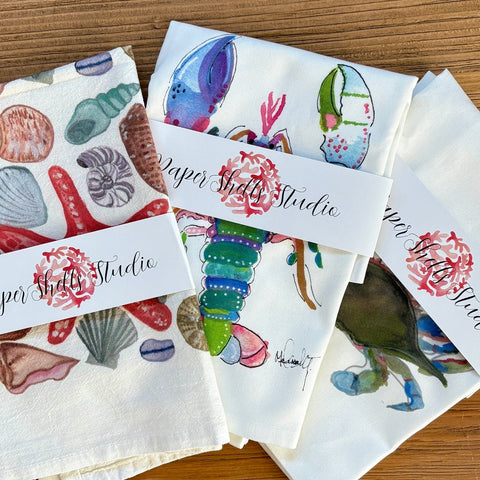 Set of fabric swatches with ocean-themed designs and 'Paper Shell Studio' branding.