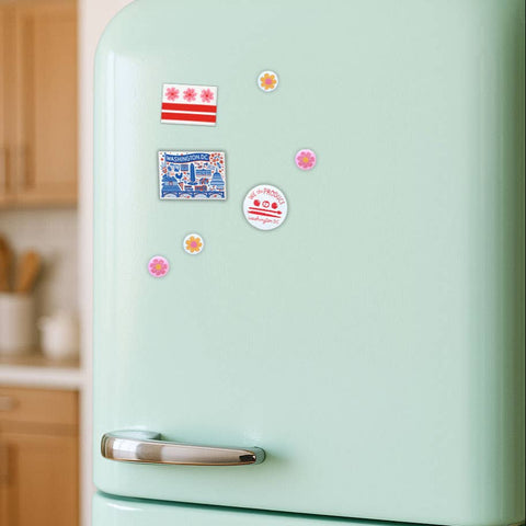 Light green refrigerator with colorful magnets in a kitchen setting