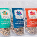Three packages of Local Eden granola in different flavors on a white background
