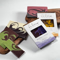 Handmade soap bars with colorful designs and packaging on a white background