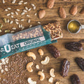 Bar U Eat Original granola bar on a wooden surface with nuts and seeds