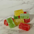 Colorful gummy cubes on a marble surface