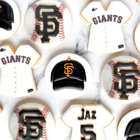 Collection of San Francisco Giants-themed cookies including jerseys, hats, and baseballs.