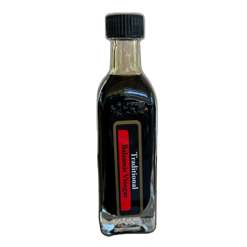 Balsamic vinegar bottle with a black cap on a white background