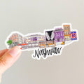 Sticker with Nashville-themed design held by a hand on a light gray background