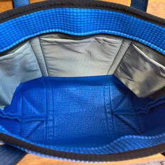 Blue and gray bag with textured interior on a wooden surface