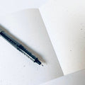Pen on a white sheet of paper with a textured surface