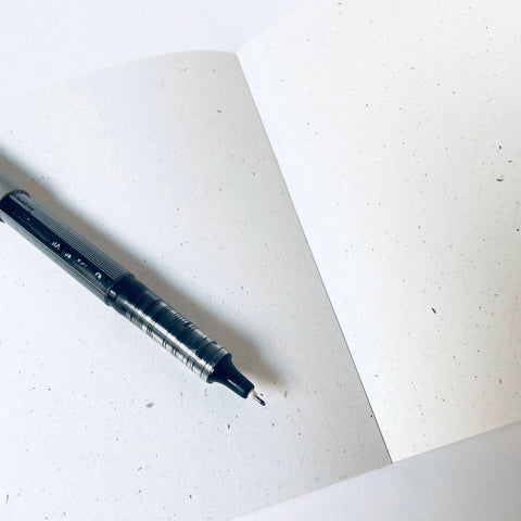 Pen on a white sheet of paper with a textured surface