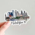 Sticker of Philadelphia skyline held by a hand on a light gray background