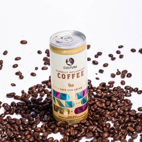 Culturi coffee can surrounded by coffee beans on a white background